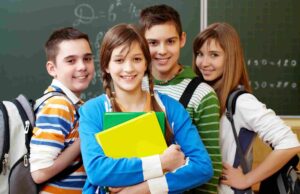 How Grammar Schools in Telford Select Students Through the 11 Plus A group of four students with backpacks and books standing together in front of a chalkboard.