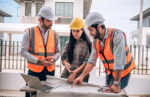 Construction Services in London: Building with Purpose and Precision Construction Team Reviewing Blueprints