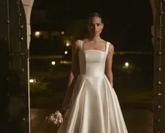 “Wedding Dress” in Sugarland, Texas USA – Because Your Dream Gown Deserves the Best Care A young woman wearing a elegant floor-length dress, standing gracefully in a well-lit room. The dress features delicate lace details and a flowing skirt, suggesting a formal or bridal occasion.